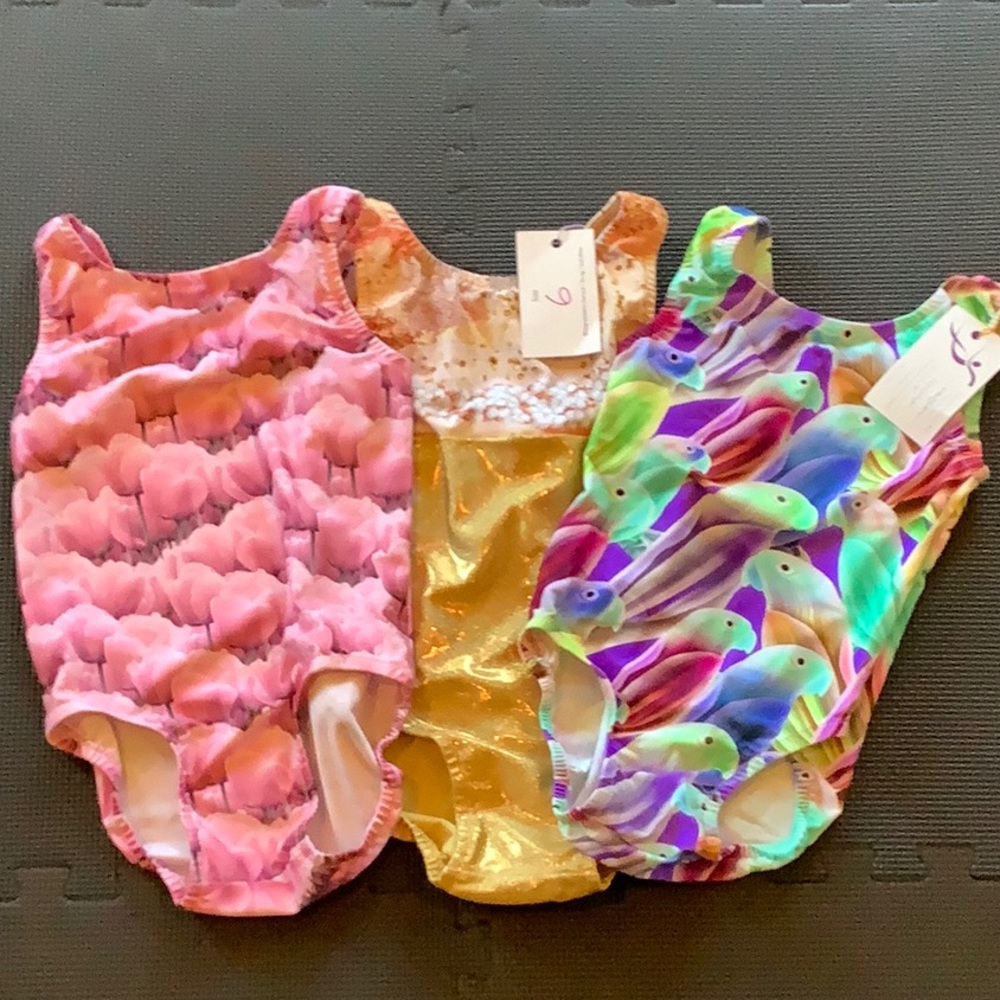 3 girl’s size 6 gymnastics leotards